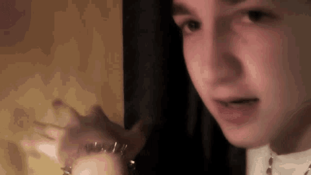 a close up of a person wearing a bracelet with spikes on it