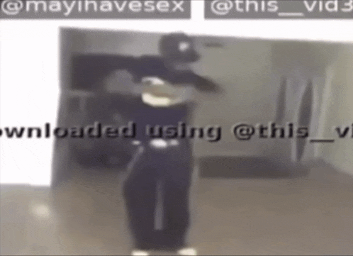 a man in a mask is dancing in a room with the words downloaded using @this_vid3