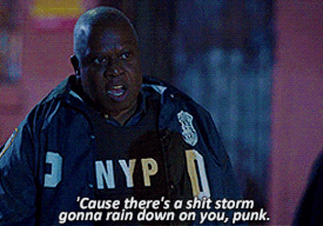 a man in a nyp shirt is talking to another man