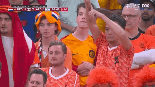 a group of people watching a soccer game on fox sports