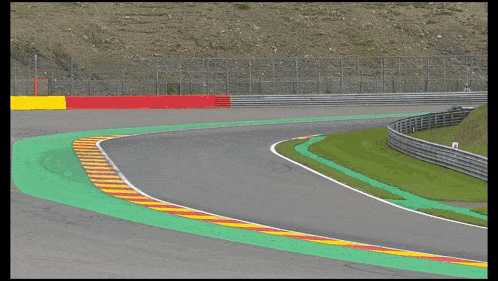 a race car with the word mercedes on the side is driving down a track