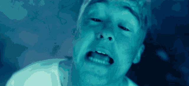 a close up of a man 's face with his eyes closed