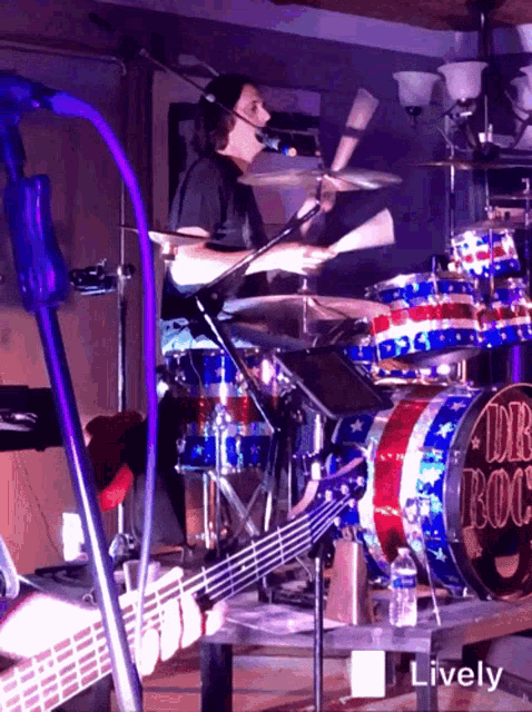 a man is playing drums in front of a drum set that says db rock on it