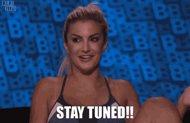 a woman says " stay tuned " in front of a blue screen