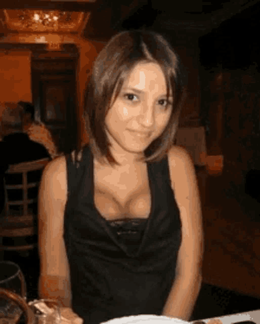 a woman sitting at a table with a plate of food