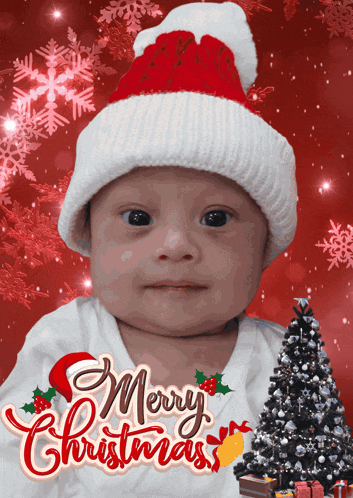 a baby wearing a santa hat with the words merry christmas written on it