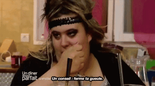a woman is sitting at a table with a sign that says un diner parfait on it