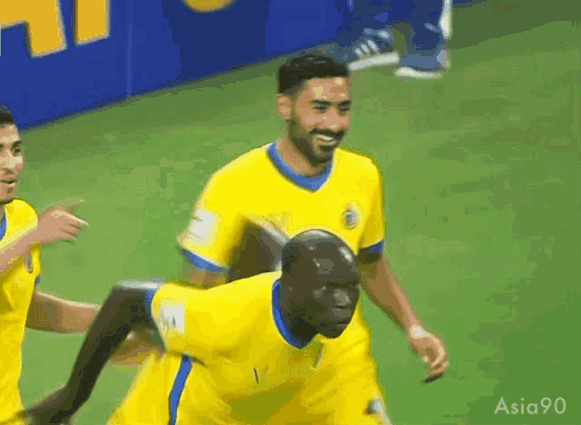 a group of soccer players are celebrating a goal with the number 1 on their jersey