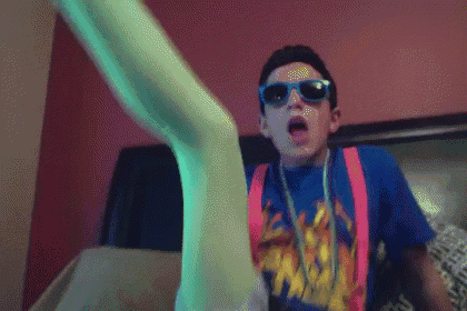 a boy wearing sunglasses and suspenders has a leg up