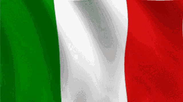 a green white and red flag is being blown in the wind