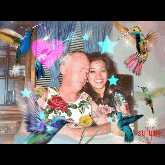 a picture of a man and woman surrounded by hummingbirds with syillylove written on the bottom right