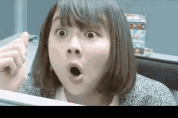 a woman making a surprised face with her mouth wide open