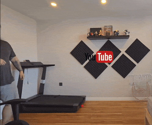 a treadmill is in a room with a youtube logo on the wall
