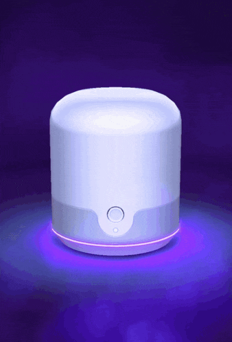 a white device with a purple light coming out of the top