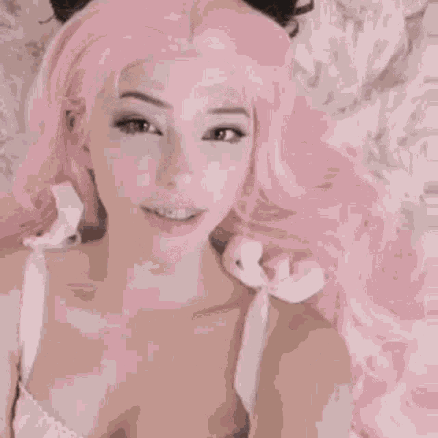 a woman with pink hair is sticking out her tongue and the words bom dio are written below her