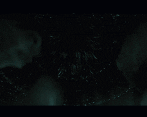 a group of aliens are looking up at a bright light