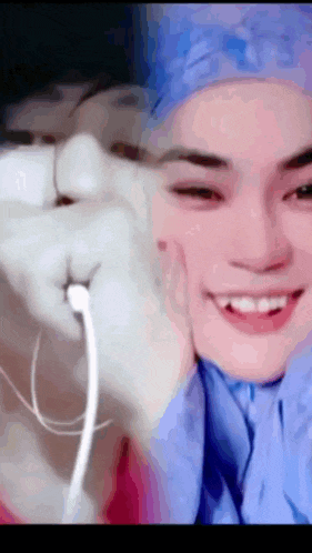a close up of a person wearing ear buds and smiling