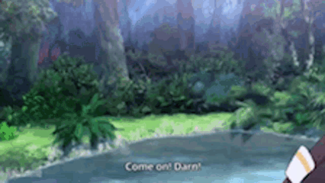 a person is standing next to a body of water in the middle of a lush green forest .
