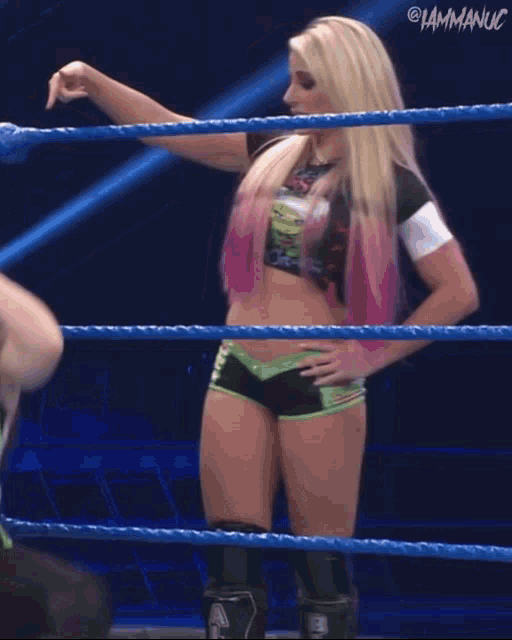 a woman in a wrestling ring with a caption that says " i am maniac "