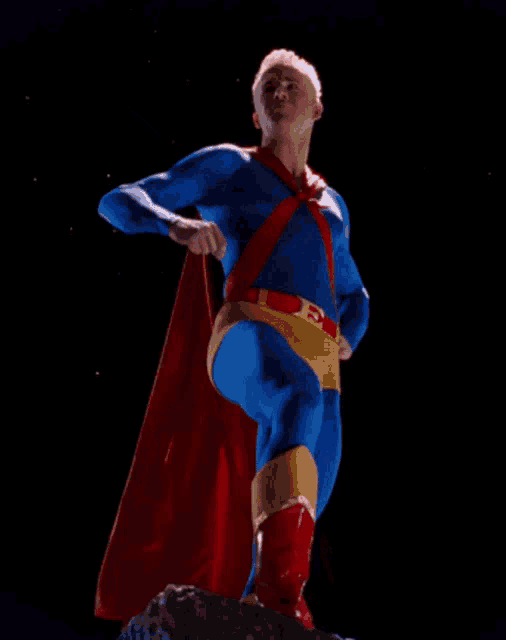 a man in a superhero costume with a red cape