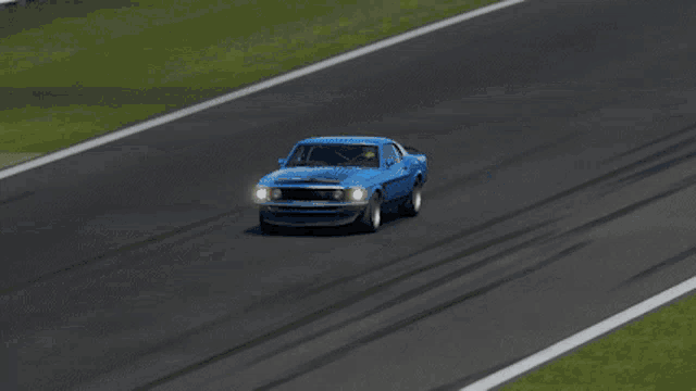 a blue car is driving down a race track in a video game