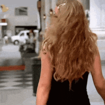 a woman with long blonde hair is wearing sunglasses and a black top