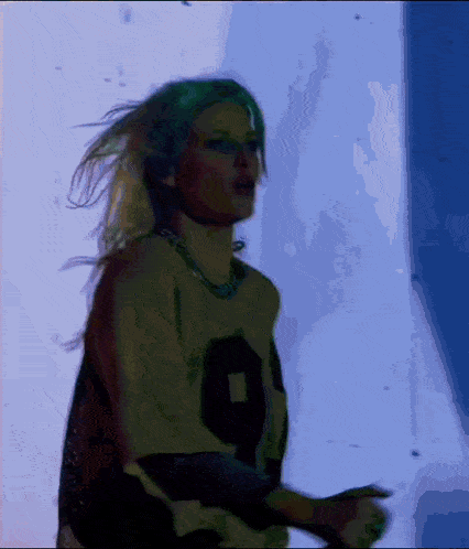 a woman wearing a number 9 jersey is dancing