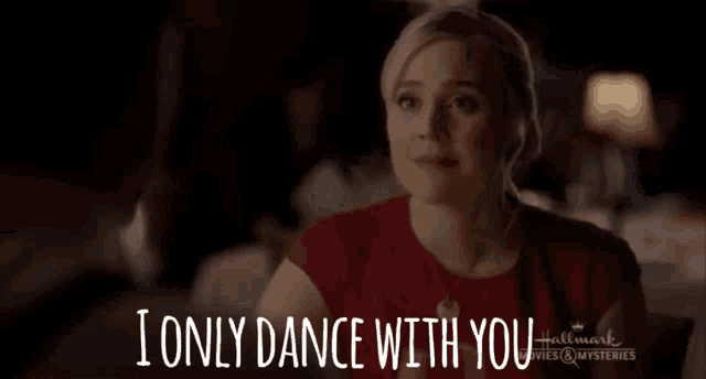 a woman is sitting at a table with the words i only dance with you behind her