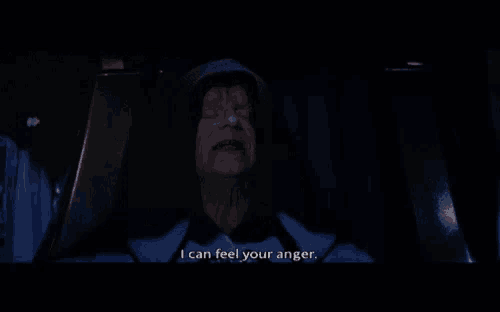 a man with a hood on says " i can feel your anger " in a dark room