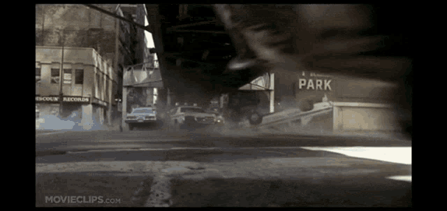 a movie clip from movieclips.com shows a car driving down a city street