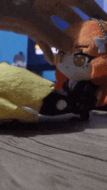 a person playing with a stuffed animal that has a white ribbon on its head