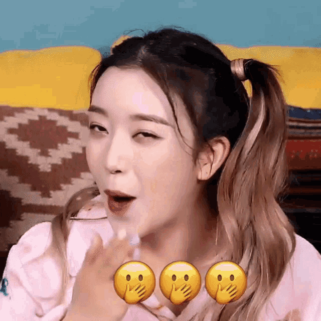 a woman is making a funny face with three smiley faces around her