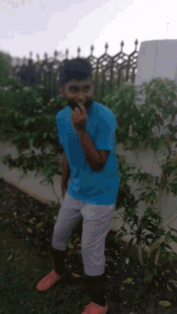 a man wearing a blue shirt that says ts