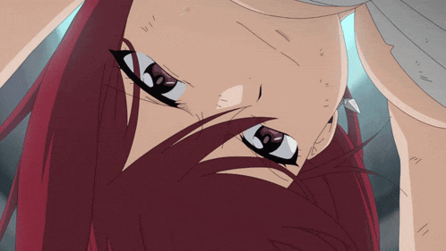 a close up of a person 's face with red hair