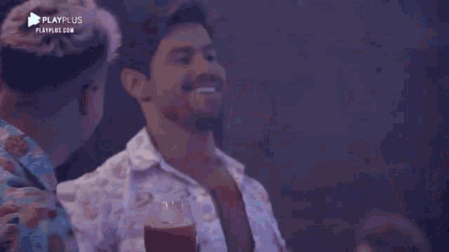 a man in a playplus shirt is dancing