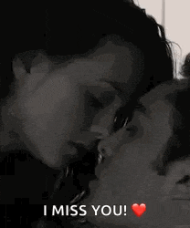 a man and a woman kissing with the words `` i miss you '' written on the bottom .