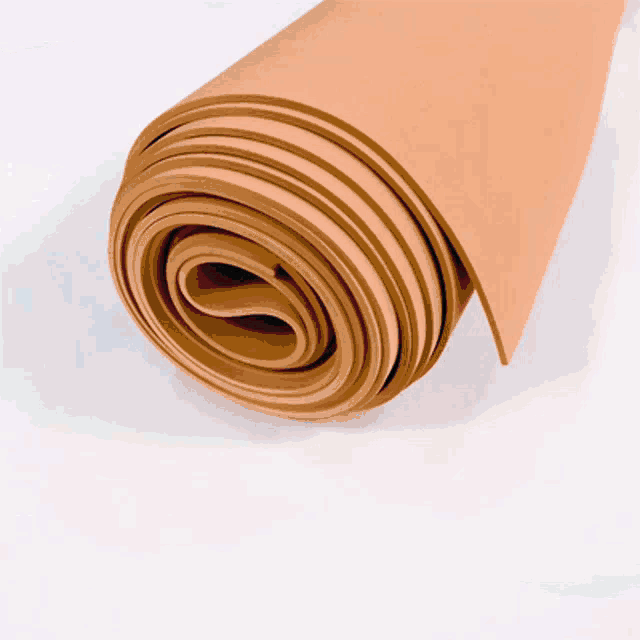 a rolled up piece of brown paper with a white background