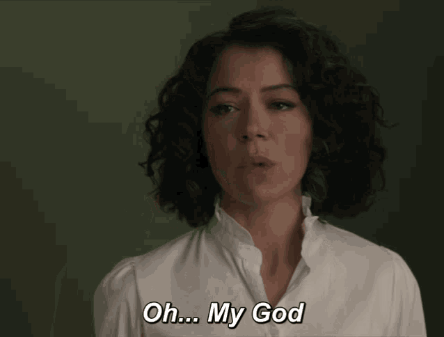 a woman says oh my god in a white shirt