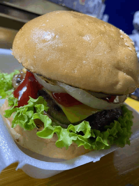 a close up of a hamburger with lettuce and ketchup