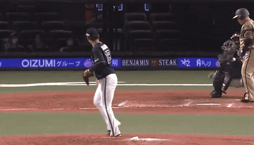 a baseball game is being played in front of a banner for benjamin steak