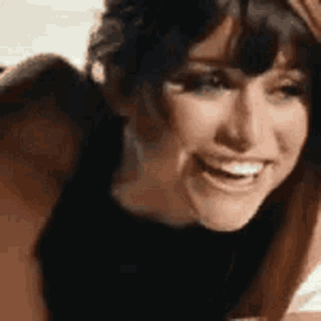 a close up of a woman 's face smiling .