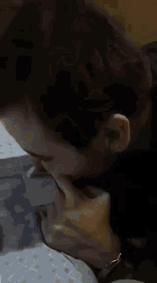 a man with a tattoo on his arm is sitting at a table eating a sandwich