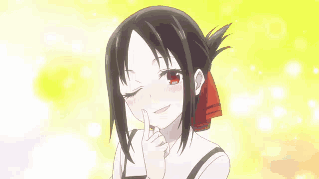 a girl with black hair and red eyes is smiling and holding her finger to her face .
