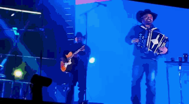 a man playing an accordion and another man playing a guitar