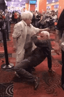 an older couple dancing in a crowded room