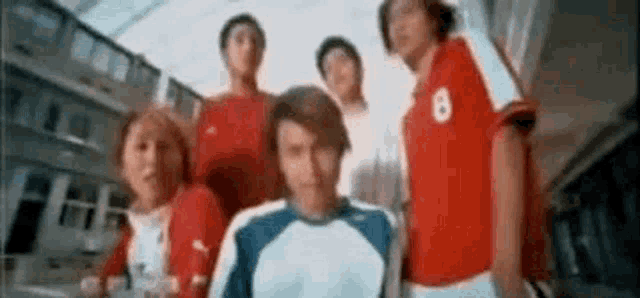 a group of soccer players are standing next to each other in a stadium .