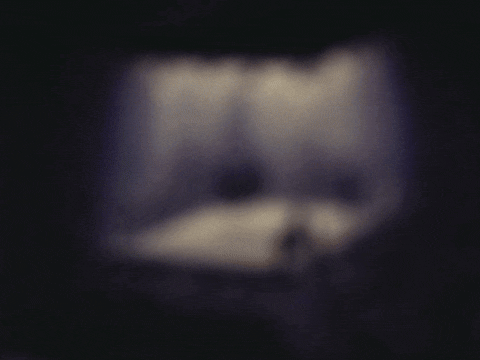 a blurry picture of a cat 's face in a dark room