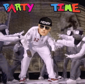 a man wearing a henry hat and sunglasses is dancing with a group of people