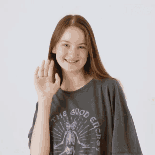 a woman wearing a t-shirt that says the good energy on it