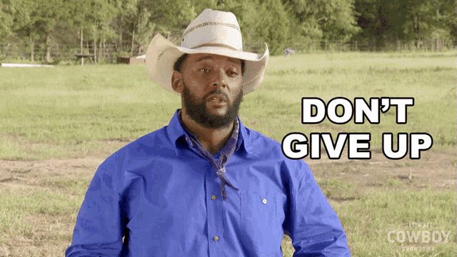 a man wearing a cowboy hat and a blue shirt says " do n't give up "